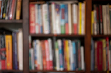 Defocused background .library shelves with books