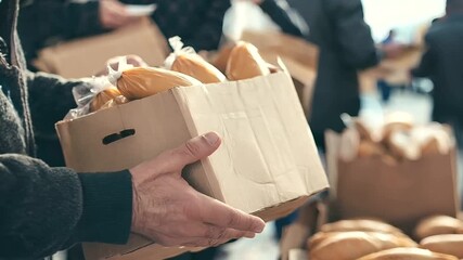 Food donation for the poor and homeless, showcasing community volunteering efforts. Giving away food supplies and groceries to people in poverty
