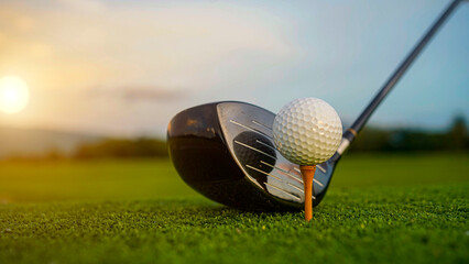 Golf clubs and balls on a green lawn in a beautiful golf course with morning sunshine.