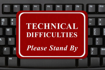  Technical Difficulties sign on keyboard