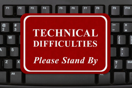 Technical Difficulties sign on keyboard