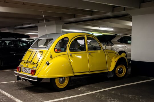 Yellow Citroen 2CV6 vintage gar parked in underground garage
