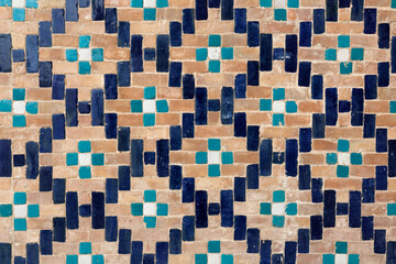 ancient ceramic tile with a traditional Arabic pattern Uzbek ornament decorates the wall of islamic Hazrati Imam mosque in Tashkent in Uzbekistan.