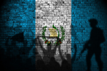 guatemala flag painting on brick wall and Protesters shadow