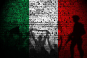 italy flag on brick wall and protesters shadow