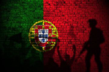 portugal flag painting on brick wall and Protesters shadow