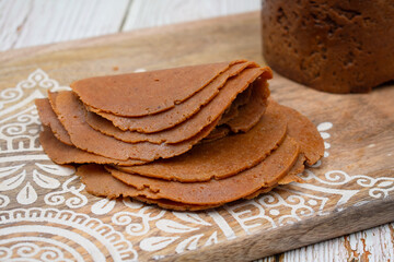 Seitan or mock meat made with vital wheat gluten,  spices. Cooked in ham maker and sliced.