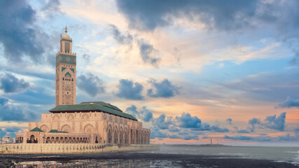 Hassan II Mosque during sunset, built on the Atlantic Ocean, showcasing impressive architecture and intricate details reflecting rich cultural heritage.