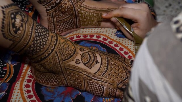 Mumbai, India 23rd July 2024: Close-up shots of an Indian bride getting henna also known as Mehendi or mehndi done. Henna pattern. Traditional Rasam or rivaz of done with henna mehandi