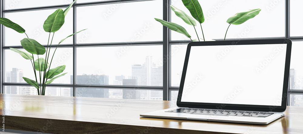 Poster laptop with blank screen on wooden desk with plants and city view through window in modern office. 3