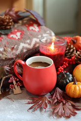 Fall season composition with cup of coffee and autumn decorations on a table. Warm autumn still life. 