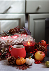 Fall season composition with cup of coffee and autumn decorations on a table. Warm autumn still life. 