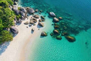 Obraz premium aerial top down view of a tropical beach with rocks and crystal clear water, ai