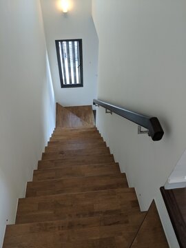 Modern Indoor Wooden Staircase, Railing in Natural Light, Minimalist Home Interior.