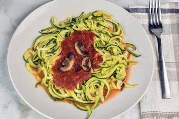zucchini noodles top with sauce and mushrooms