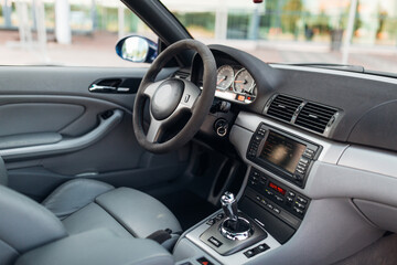Interior of car with leather seats big multimedia monitor dashboard and control panel view from rear seat row