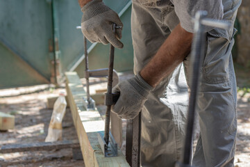 Carpenter clamps are fixed to boards. Gluing joinery in the workshop..
