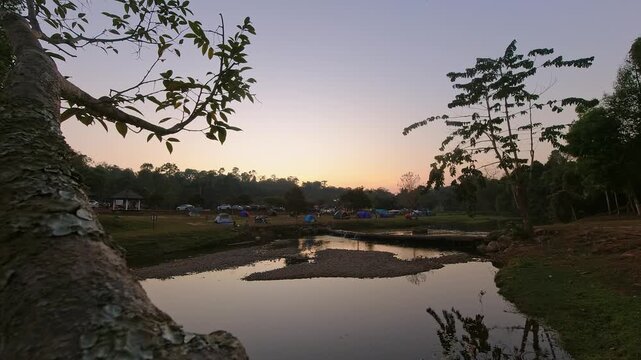 Day to night time lapse of Khao Yai National Park open campsite, Lam Ta Khong Campground. Visitors enjoy leisure camp in Thailand after sunset stay over night in national park jungles area outdoors