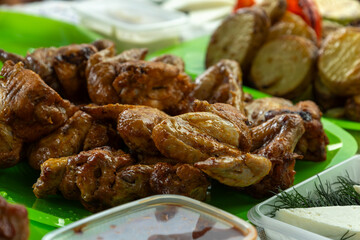 Fried chicken wings close-up on a set family table