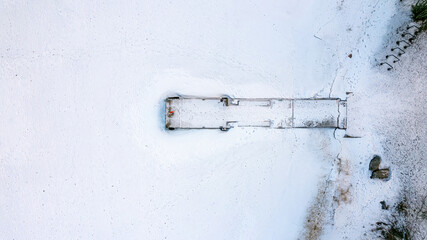 drone aerial view over Helsinki sea line in winter time - beach and marina covered with snow