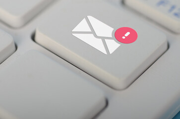 The image of an email icon with an exclamation mark on a keyboard button can be used to represent...