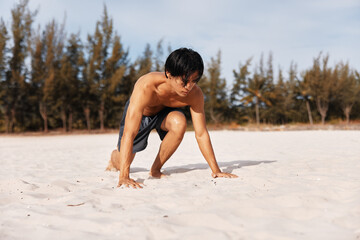 Active Lifestyle: Muscular Asian Athlete Enjoying Cardio Workout on a Sandy Beach at Sunset