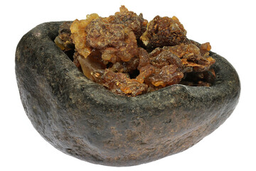 myrrh resin from Oman in a stone bowl isolated on white background