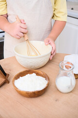 A child enthusiastically baking in a cozy kitchen filled with various delicious ingredients
