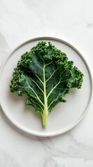 Fototapeta premium Fresh kale leaf on white plate, healthy