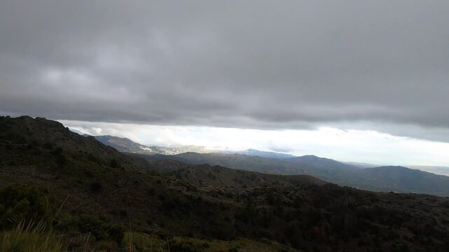 Fog and clouds on hiking trail to Maroma peak in thunderstorm day, Sierra Tejeda, Spain 