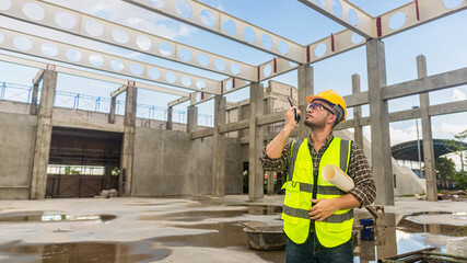 Architects engineer are checking the progress of the building project and checking the accuracy of the building plan.