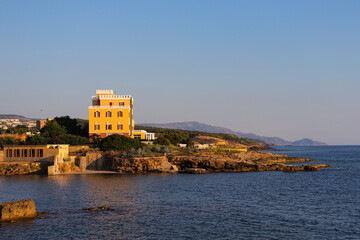 Yellow Villa Overlooking Rocky Coastline