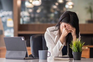 businessman sitting in an office expressing concern as the financial institution has filed for...