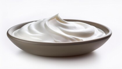 a bowl of white cream is sitting on a white background