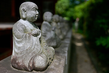 A row of Buddha statues near Takao Yakuoin Temple