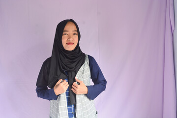 Portrait of Asian Muslim female student in white shirt smiling at the camera