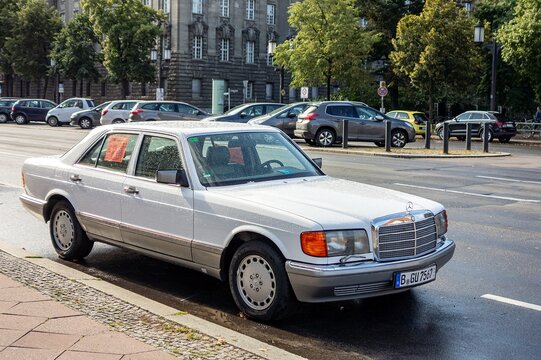 Vintage Mercedes 380 SEL saloon car from 1980s parked on street in Berlin