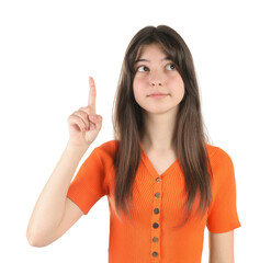 Portrait of cute teenage girl pointing at something on white background