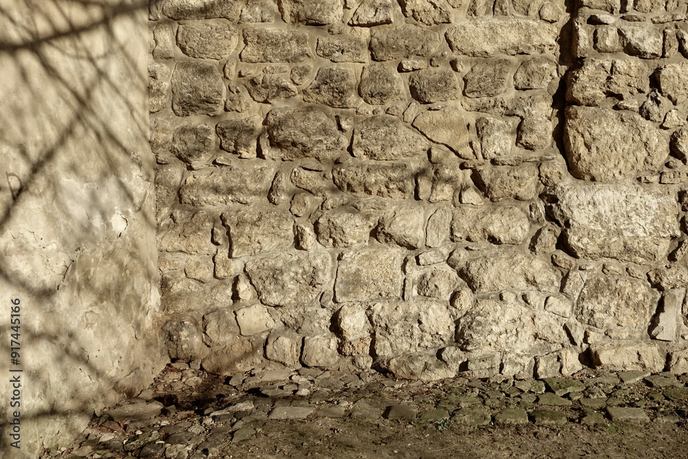 Poster ancient stone wall made of boulders with textured surface in a natural setting during daylight