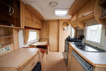 Cozy Caravan Interior with Kitchen and Sleeping Area. Ideal for Glamping, Camping, and Mobile Living