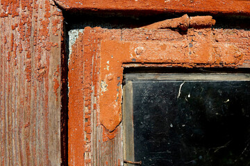 Close-up of an Old Painted Wooden Window Revealing Weathered Textures and Glass Details in a Rustic Home