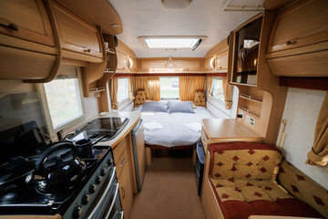 Cozy Caravan Interior with Kitchen and Sleeping Area. Ideal for Glamping, Camping, and Mobile Living
