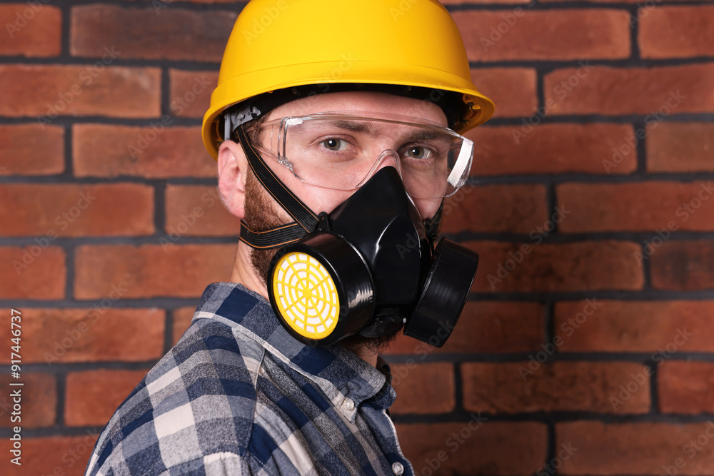 Sticker Man in respirator mask and hard hat near red brick wall