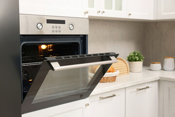 Fototapeta premium Open electric oven in kitchen. Cooking appliance