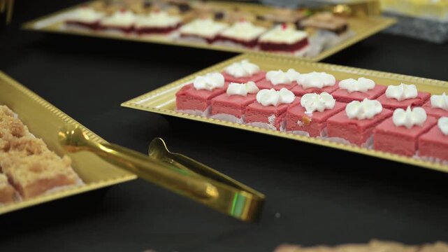 Candy bar, Sweets on stands. Delicious desserts at the banquet, sponge cakes, shortbread tarts. move camera footage. Close up view