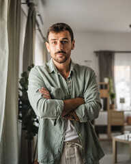 Portrait of adult serious man stand at home