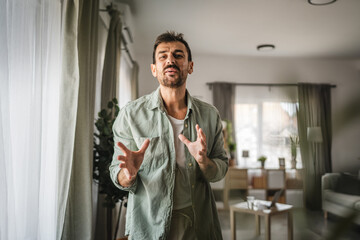 Portrait of adult man stand and smile at home