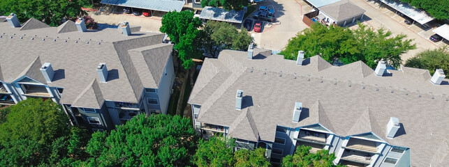Panorama aerial view apartment complex with covered parking garage tall oak trees in North...