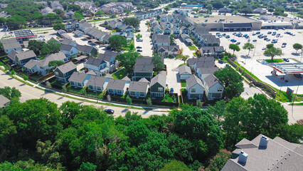 Two story single family for rent near large grocery story with gas station in North Arlington, suburbs Dallas Fort Worth Metroplex area, lush greenery trees residential community, aerial view