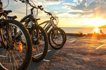 Fototapeta premium Bicycles lined up near the sea at sunset, highlighting outdoor recreation and nature's beauty.